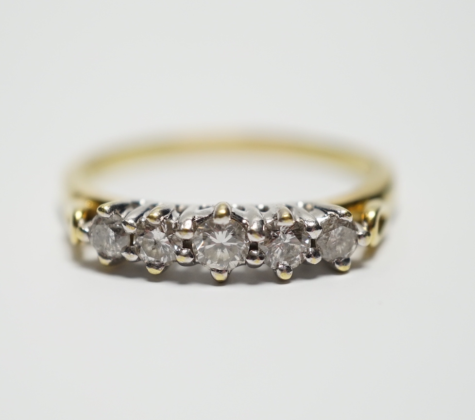 A modern 18ct gold and graduated five stone diamond set half hoop ring, size T, gross weight 4.4 grams.